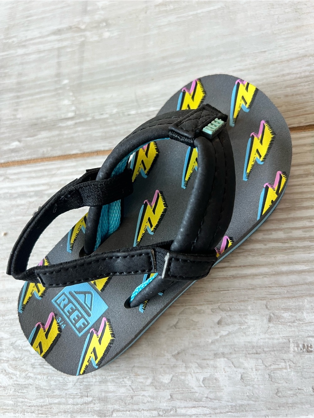 Reef Kids Black Flip Flop with Yellow & Pink Lightning Accents